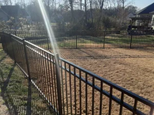 A black aluminum residential fence built by trusted Chattanooga fence company All Fences Co. enclosing a back yard.