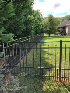 An ornamental steel fence built by trusted Chattanooga fence company All Fences Co. enclosing a back yard.
