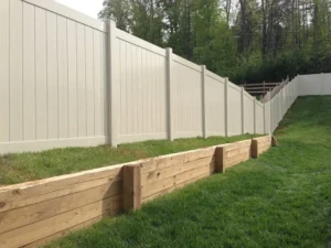 A beige vinyl privacy fence built by trusted Chattanooga fence company All Fences Co. enclosing a back yard.